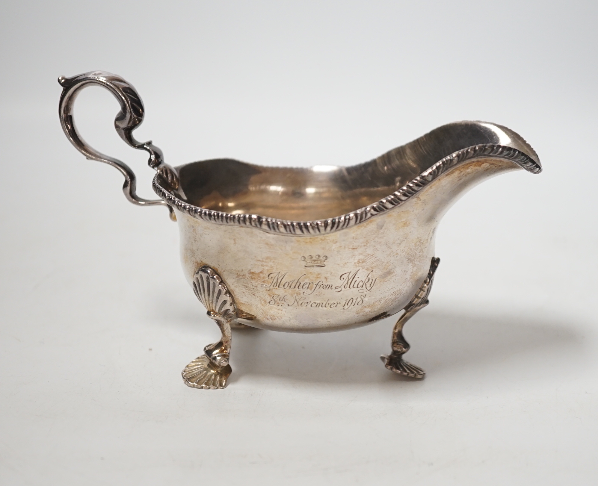 A George V silver sauceboat, on three shell feet, Thomas of New Bond Street, London, 1918, length 17cm, 8oz.